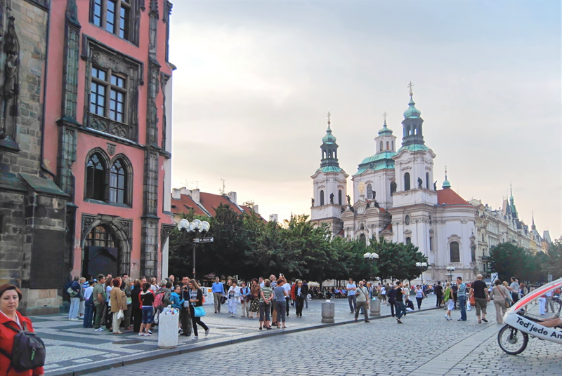 29 - The monumental Baroque St. Nicholas Church rising above the cobblestone Old Town Square in Prague